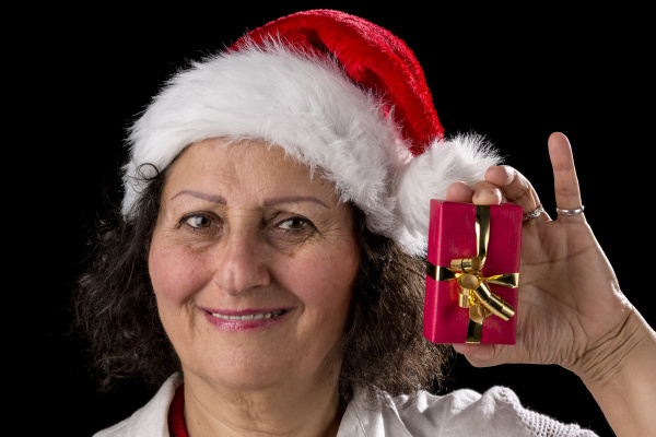 Venerable Woman With Red Cap Holding Small Gift Stock Photo