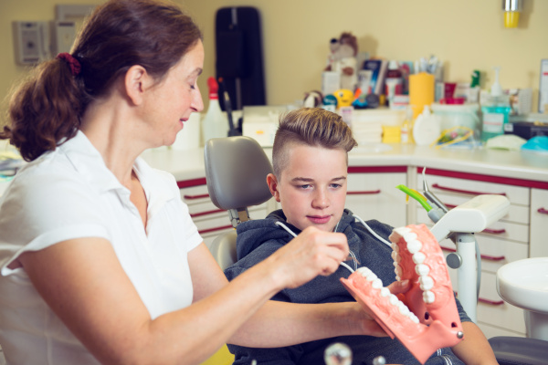 boy is treated by female dentist