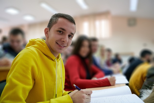 student-taking-notes-while-studying-in-high-school-stock-photo