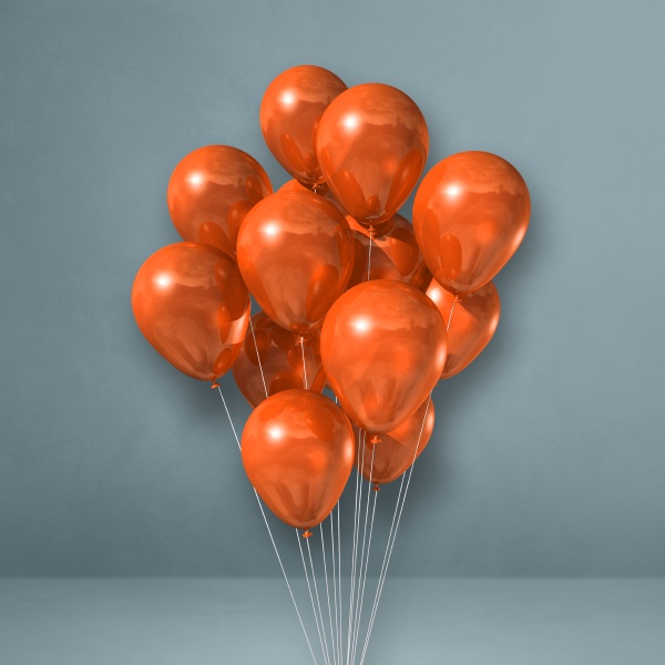 orangefarbene luftballons buendeln sich auf einem