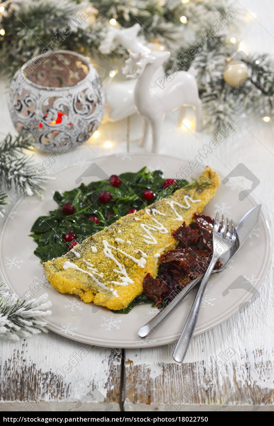 fish-fillet-in-polenta-with-spinach-and-dried-tomatoes-stock-photo